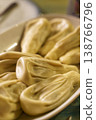 Georgian khinkali juicy meat dumplings on a ceramic plate in a restaurant. High quality photo 138766796