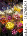 Bunches of colorful tulips in buckets at a street flower market. Vibrant spring bouquet selection of red, yellow and pink tulips at a florist shop. High quality photo 138766808