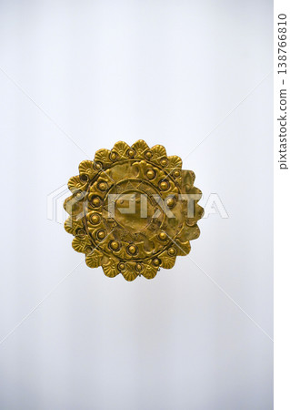 Isolated Ancient Round Gold Jewelry Artifact on White Background. High quality photo Isolated Ancient Round Gold Jewelry Artifact on White Background. High quality photo 138766810