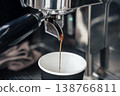 Fresh Espresso Flowing from Portafilter into Takeaway Paper Cup. High quality photo 138766811