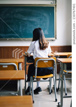 Female student sitting on a chair in the classroom 138767401