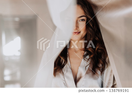 The beautiful woman standing near balcony window i 138769191