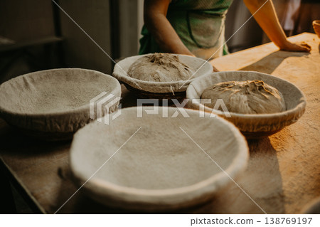 hands kneading bread dough on a cutting board hands kneading bread dough on a cutting board 138769197