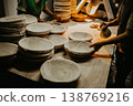 female hands in flour closeup kneading dough on table 138769216