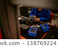 Close-up of hands of young computer engineer fixing broken pc parts at the desk in the home office 138769224