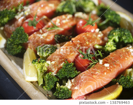 Salmon With Herbs. Ovenbaked Salmon Served With Greens And Citrus Slices Salmon With Herbs. Ovenbaked Salmon Served With Greens And Citrus Slices 138769463