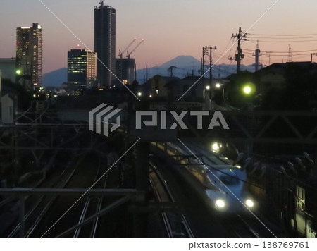 June 2, 2017: A Tokaido Shinkansen N700 series train running near Nishimine-cho, Ota Ward, at dusk. June 2, 2017: A Tokaido Shinkansen N700 series train running near Nishimine-cho, Ota Ward, at dusk. 138769761