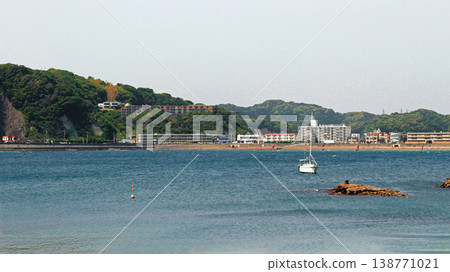 A scene from Zushi Beach in Kanagawa Prefecture: a calm blue sea and a coastline dotted with sailboats. A scene from Zushi Beach in Kanagawa Prefecture: a calm blue sea and a coastline dotted with sailboats. 138771021