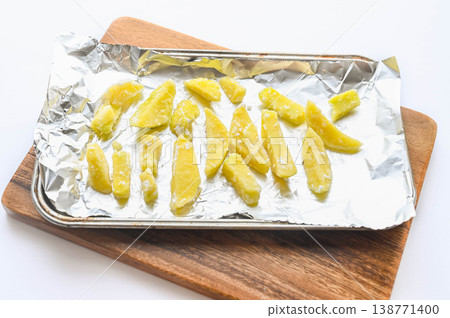 Potatoes coated in flour before baking 138771400