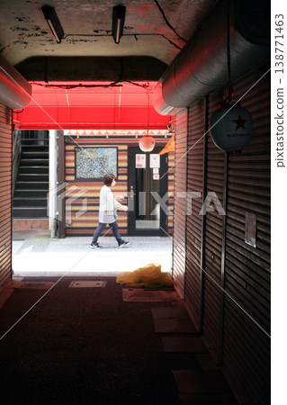 A bar in a back alley during the daytime and a woman A bar in a back alley during the daytime and a woman 138771463