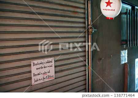 The shutters and signs of a bar in an alleyway The shutters and signs of a bar in an alleyway 138771464