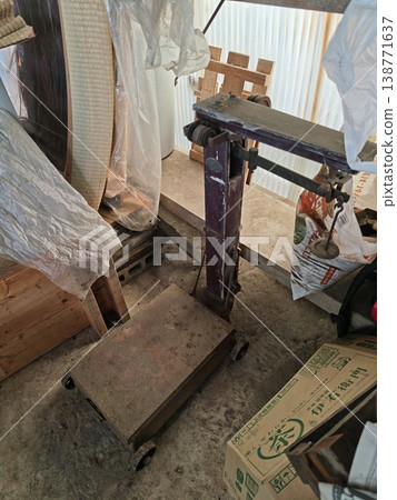 An old scale and a cluttered storage space 138771637
