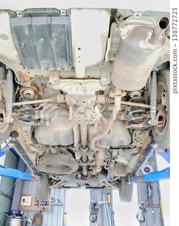 Underbody inspection of a car; vehicle lifted up; repair shop 138772725