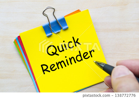 Quick reminder written on yellow sticky note representing urgency and daily task memory Quick reminder written on yellow sticky note representing urgency and daily task memory 138772776