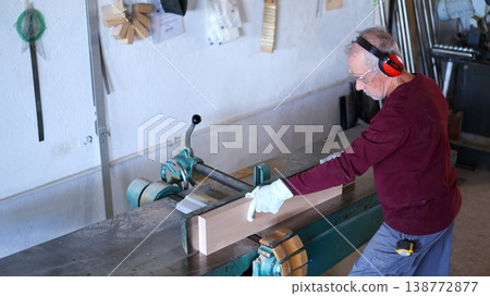 Senior man working wood with jointer machine 138772877