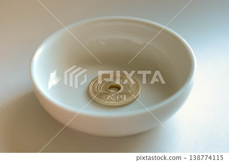 A five-yen coin on a small plate A five-yen coin on a small plate 138774115