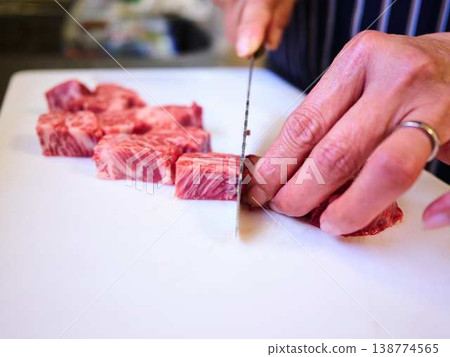 A female chef cutting domestically produced Japanese Black beef thigh meat A female chef cutting domestically produced Japanese Black beef thigh meat 138774565