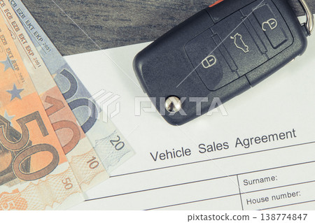 Car key, euro banknotes and vehicle sales agreement. Sales or purchases new or used vehicle Car key, euro banknotes and vehicle sales agreement. Sales or purchases new or used vehicle 138774847