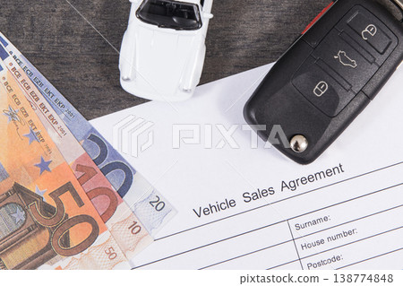 White toy car, car key, euro banknotes and vehicle sales agreement White toy car, car key, euro banknotes and vehicle sales agreement 138774848