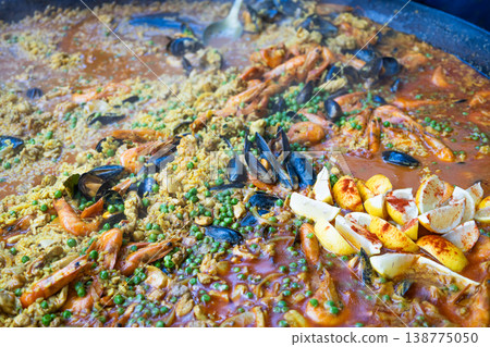 Large pan of traditional seafood paella cooking at Borough Market 138775050