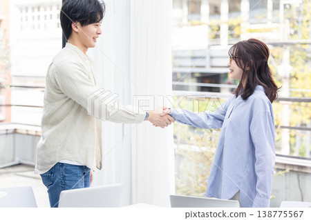 Male and female shaking hands 138775567