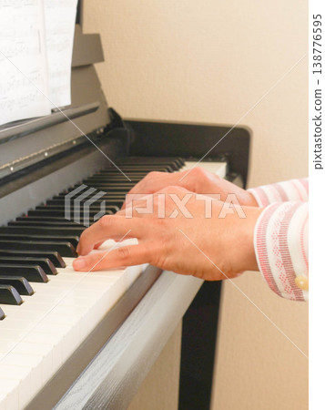 The hands and fingers of a man playing the piano. The hands and fingers of a man playing the piano. 138776595