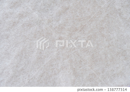 Close-up of soft white mohair fabric with delicate fibers and fluffy texture. Close-up of soft white mohair fabric with delicate fibers and fluffy texture. 138777314
