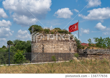 Historic Theodosian Walls with Turkish flag flying proudly under a blue sky Istanbul, Turkey Historic Theodosian Walls with Turkish flag flying proudly under a blue sky Istanbul, Turkey 138777656