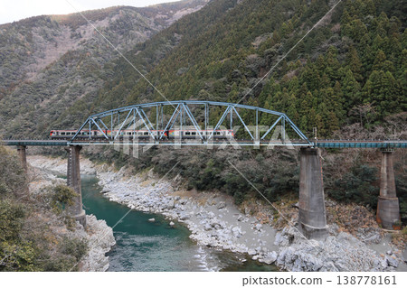 JR Shikoku's Limited Express Nanpu crosses the No. 2 Yoshinogawa Bridge in Oboke Gorge (Okayama on the left, Kochi on the right). JR Shikoku's Limited Express Nanpu crosses the No. 2 Yoshinogawa Bridge in Oboke Gorge (Okayama on the left, Kochi on the right). 138778161