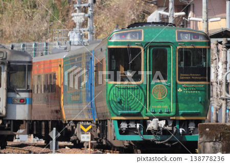JR Shikoku's sightseeing train "Shikoku Mannaka Sennen Monogatari" is parked alongside a regular train at Oboke Station on the Dosan Line. JR Shikoku's sightseeing train "Shikoku Mannaka Sennen Monogatari" is parked alongside a regular train at Oboke Station on the Dosan Line. 138778236