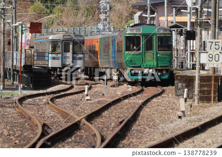 JR Shikoku's sightseeing train "Shikoku Mannaka Sennen Monogatari" is parked alongside a regular train at Oboke Station on the Dosan Line. JR Shikoku's sightseeing train "Shikoku Mannaka Sennen Monogatari" is parked alongside a regular train at Oboke Station on the Dosan Line. 138778239