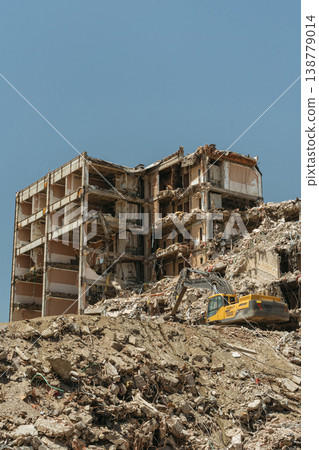A destroyed apartment building ruins under active demolition A destroyed apartment building ruins under active demolition 138779014