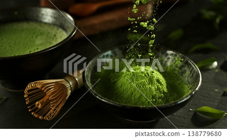 Freeze Motion Detail Shot of Sprinkling Matcha Powder Freeze Motion Detail Shot of Sprinkling Matcha Powder 138779680
