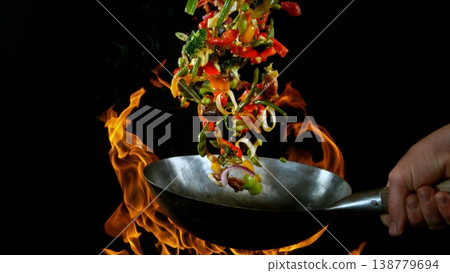 Freeze Motion of Flying Asian Meal with Vegetable and Meat into Wok Pan 138779694