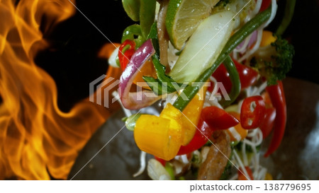 Freeze Motion of Flying Asian Meal with Vegetable and Meat into Wok Pan Freeze Motion of Flying Asian Meal with Vegetable and Meat into Wok Pan 138779695