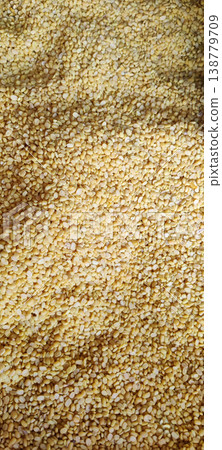 Split mung beans texture background with raw yellow lentils filling full frame 138779709