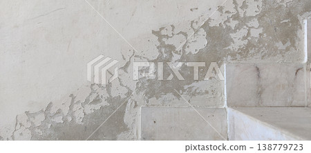 Peeling wall paint near tiled surface showing moisture damage and cracked plaster texture Peeling wall paint near tiled surface showing moisture damage and cracked plaster texture 138779723
