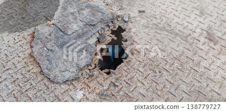 Rusty metal sheet with hole caused by water damage and long term moisture exposure 138779727