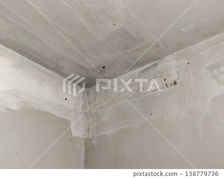 Room corner with paint marks and moisture stains 138779736