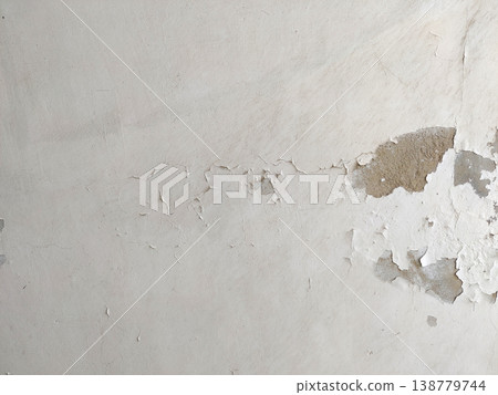 Wall paint peeling due to seepage exposing inner plaster and moisture damage indoors Wall paint peeling due to seepage exposing inner plaster and moisture damage indoors 138779744