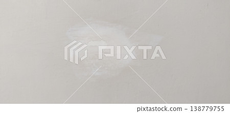 Wall repair spot with putty smoothing and warm off white base color before repaint stage 138779755