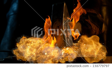 Close-up of blacksmith forging glowing hot iron on anvil with flying sparks Close-up of blacksmith forging glowing hot iron on anvil with flying sparks 138779797