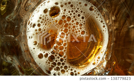 Pouring Beer into Pint Glass on Old Wooden Table, Top Down View. Pouring Beer into Pint Glass on Old Wooden Table, Top Down View. 138779823