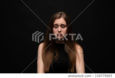 Young woman dealing with sadness, grief, depression, and mental health issues, feeling emotional with closed eyes Young woman dealing with sadness, grief, depression, and mental health issues, feeling emotional with closed eyes 138779865
