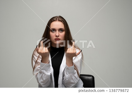 Young woman showing middle fingers with serious expression, expressing anger, frustration, and defiance Young woman showing middle fingers with serious expression, expressing anger, frustration, and defiance 138779872