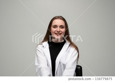 Young adult woman smiling, demonstrating happiness and positivity in a casual white shirt, looking at camera Young adult woman smiling, demonstrating happiness and positivity in a casual white shirt, looking at camera 138779875