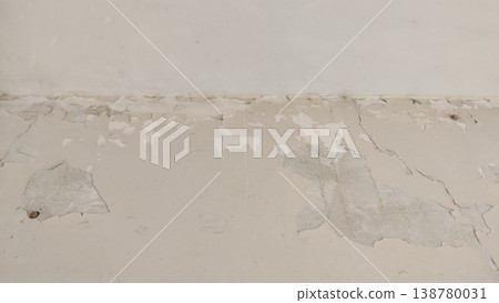 Damaged wall surface with peeling paint and aged plaster 138780031