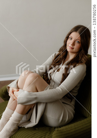Woman Embracing Knees. Cozy Woman With Warm Smile. Relaxed Lady Holding Her Knees In Comfy Chair 138780256