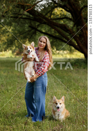 Child Woman Playing. Teen Girl Dressed Casually With Her Dog In Lush Green Natural Setting 138780315
