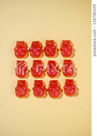 Jelly gummy bears flat lay, fruit vitamins on bright background, food supplements.Orange vitamins on yellow background 138780329